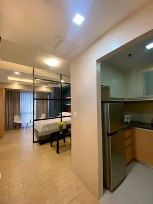 a kitchen and living room with a bed in the background at Place to stay in Pasay in Manila