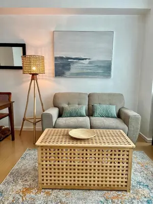 a living room with a couch and a coffee table at Charming 2-BR Condo in BGC in Manila