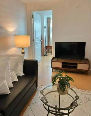 a living room with a couch and a glass table at Charming 1-BR in BGC in Manila