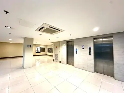 an empty lobby with elevators in a building at Apartment near Airport at One Palm Tree Villas in Manila