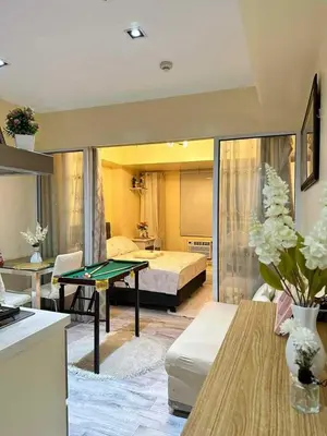 a living room with a pool table and a bedroom at AZURE RESIDENCES near International AIRPORT MANILA in Manila