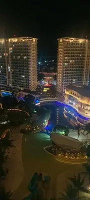 a view of a city at night with tall buildings at AZURE RESIDENCES near International AIRPORT MANILA in Manila