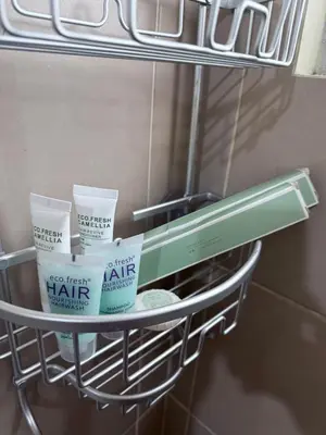 a shelf with four containers of hair products on it at 1BR Staycation at Avida Towers SM Sucat in Manila