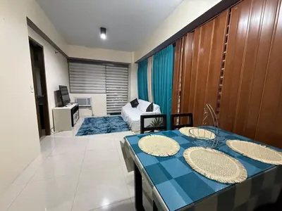a living room with a table and a couch at 1 Bedroom Apartment Across NAIA T3 in Manila