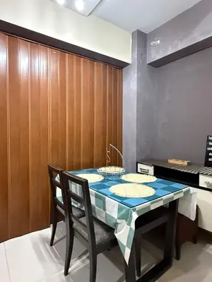 a dining room with a table and chairs at 1 Bedroom Apartment Across NAIA T3 in Manila