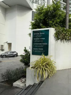 a sign in front of a building with a parking lot at Metro Suites at Novotel Suites Acqua in Manila