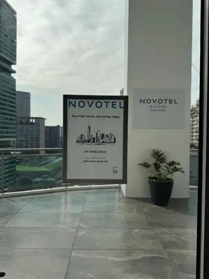 a sign on the side of a building at Metro Suites at Novotel Suites Acqua in Manila