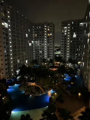 a view of a city at night with buildings at DMV Trinity Stay in Manila