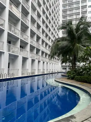 an empty swimming pool in front of a building at DMV Trinity Stay in Manila