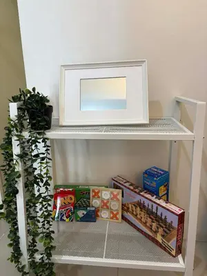 a shelf with a mirror on top of it at Cozy City Escape - Jazz Residences in Manila