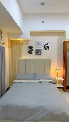 a bedroom with a large bed in a room at A Studio Unit in McKinley Near Venice Grand Canal Mall in Manila