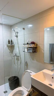 a bathroom with a shower and a toilet and a sink at A Studio Unit in McKinley Near Venice Grand Canal Mall in Manila