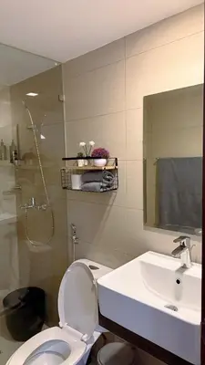 a bathroom with a toilet and a sink and a shower at A Studio Unit in McKinley Near Venice Grand Canal Mall in Manila