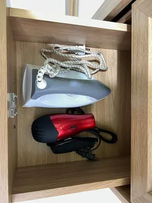 a wooden drawer with a fire extinguisher in it at Near Vista Mall Taguig BGC with Overlooking Veranda Netflix and Pay Parking in Manila