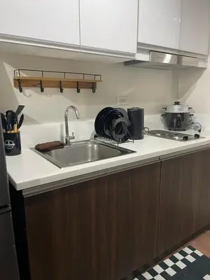 a kitchen counter with a sink and a stove at Hailar Property Management in Manila