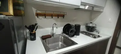 a kitchen counter with a sink and a refrigerator at Hailar Property Management in Manila