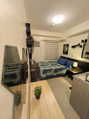 a room with a bed and a table and a couch at FSZAirbnb in Manila