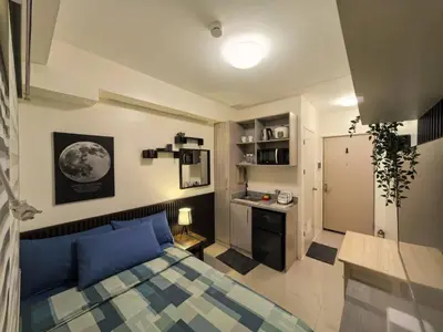 a bedroom with a blue bed in a room at FSZAirbnb in Manila