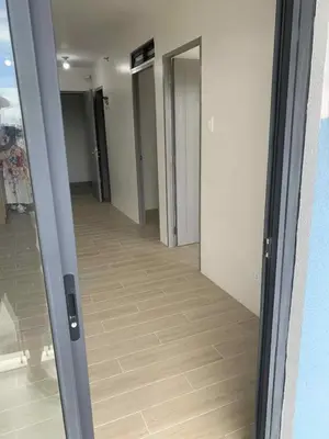 an open door to a hallway in a building at Cozy oozy apartment in Manila