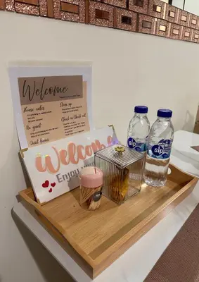 a shelf with two bottles of water and a welcome sign at Casa Doña at Kasara Urban Resort Residences in Manila