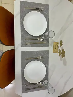 a table with two mirrors and glasses on it at Mandarin Suite Stay in Manila