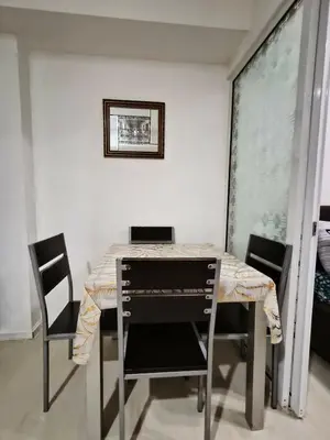a dining room table with chairs and a picture on the wall at Azure Urban Resort residence's Staycation by angkol limo in Manila