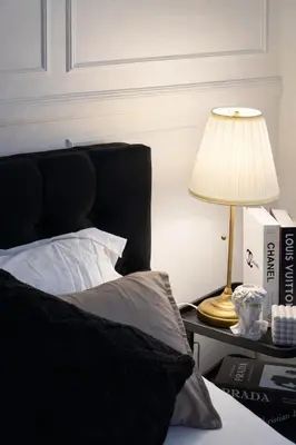 a bed with a lamp on a table next to a bed at Calme Corner Azure Urban Residences Maldives Tower in Manila