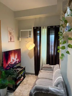a room with a bed and a flat screen tv at Luxe staycation by Joy at Charm Residence Cainta in Manila