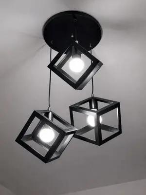 three black lights hanging from a ceiling at Maison Inea in Manila