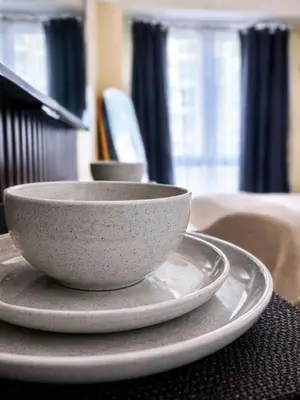 two white bowls sitting on a plate on a table at Maison Inea in Manila