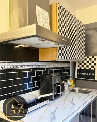 a kitchen with a sink and a microwave at Azure Staycation by Adie Luxe Haven in Manila
