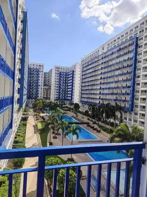 a balcony with a view of a resort at Sea Residences Feliz in Manila