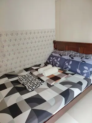 a bedroom with a bed with a black and white at Sea Residences Feliz in Manila
