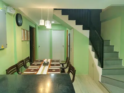 a dining room with a long table and a staircase at Private Room Casa de los Reyes Kings' HouseHomestay in San Pedro