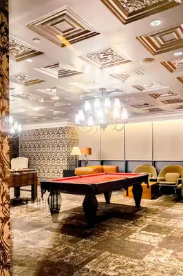 a ping pong table in a room with chairs at Designer Pad Town with Free Pool, Gym and Smart TV and Fast Wifi in Manila