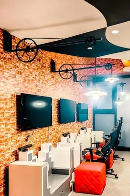 an office with a brick wall and desks and chairs at Poblacion Makati with Pool, Gym, Jacuzzi, Pool Table and fast wifi in Manila