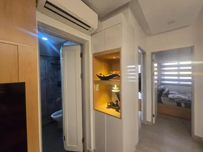 a bathroom with a sink and a toilet in a room at The Sunset Suite at Torre 3916 in Manila