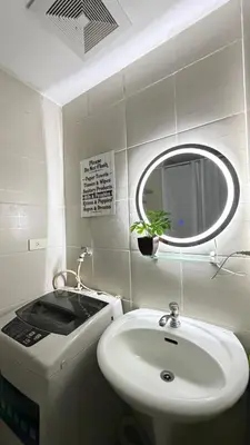 a bathroom with a sink and a mirror at Jazz staycation makati by as in Manila
