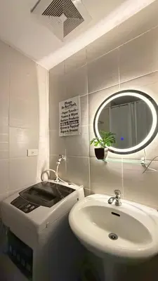 a bathroom with a sink and a mirror at Jazz staycation makati by as in Manila