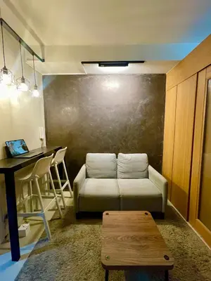 a living room with a couch and a table at A&K Staycations by Shell Residences MOA in Manila