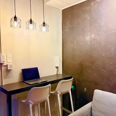 a laptop computer sitting on a desk in a room at A&K Staycations by Shell Residences MOA in Manila