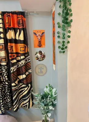 a room with curtains and a potted plant at Cozy African Themed Unit in Parañaque in Manila