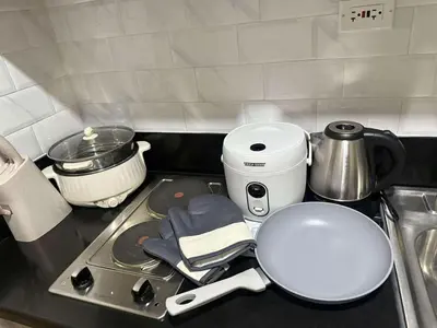 a kitchen counter with a stove with a pot on it at Hidden All in Comfy Luxe Stay MOA Pasay in Manila