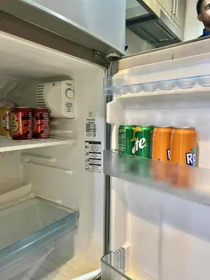 an open refrigerator with food and drinks in it at Hidden All in Comfy Luxe Stay MOA Pasay in Manila