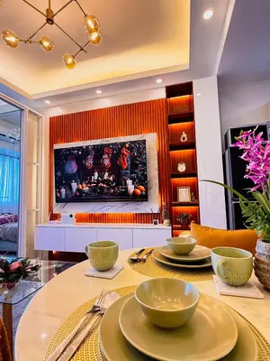 a dining room with a table with a fireplace at Makati Staycation by Jing in Manila