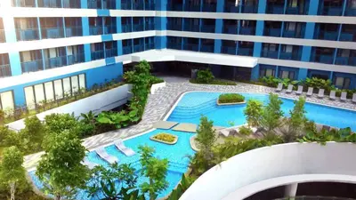 an aerial view of a building with a swimming pool at Makati Staycation by Jing in Manila