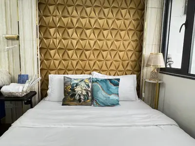 a bed with two pillows on top of it at Shore 2 Near MOA Arena IKEA Okada in Manila