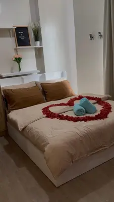 a bed with a flower decoration on it at Lovekin's Nest at The Verdin in General Trias