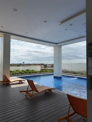 a patio with two chairs and a swimming pool at Lovekin's Nest at The Verdin in General Trias