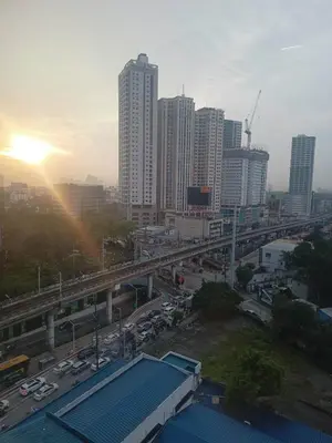 a view of a city with a bridge and traffic at InMer's D Staycation in Manila